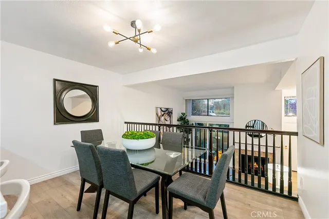 a view of a dining room with furniture and a chandelier
