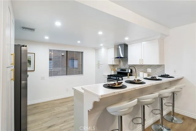 a kitchen with a table chairs stove and cabinets