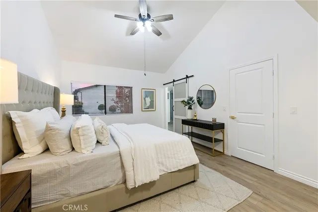 a bedroom with a bed a chandelier and closet