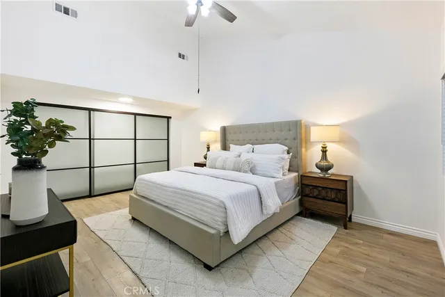 a bedroom with a bed and a potted plant