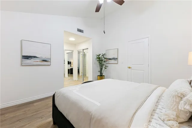 a spacious bedroom with a bed and a chandelier