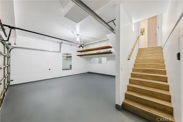 a view of a room with stairs and a ceiling fan