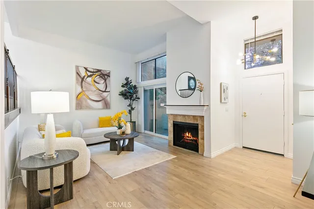 a living room with furniture a clock and a fireplace