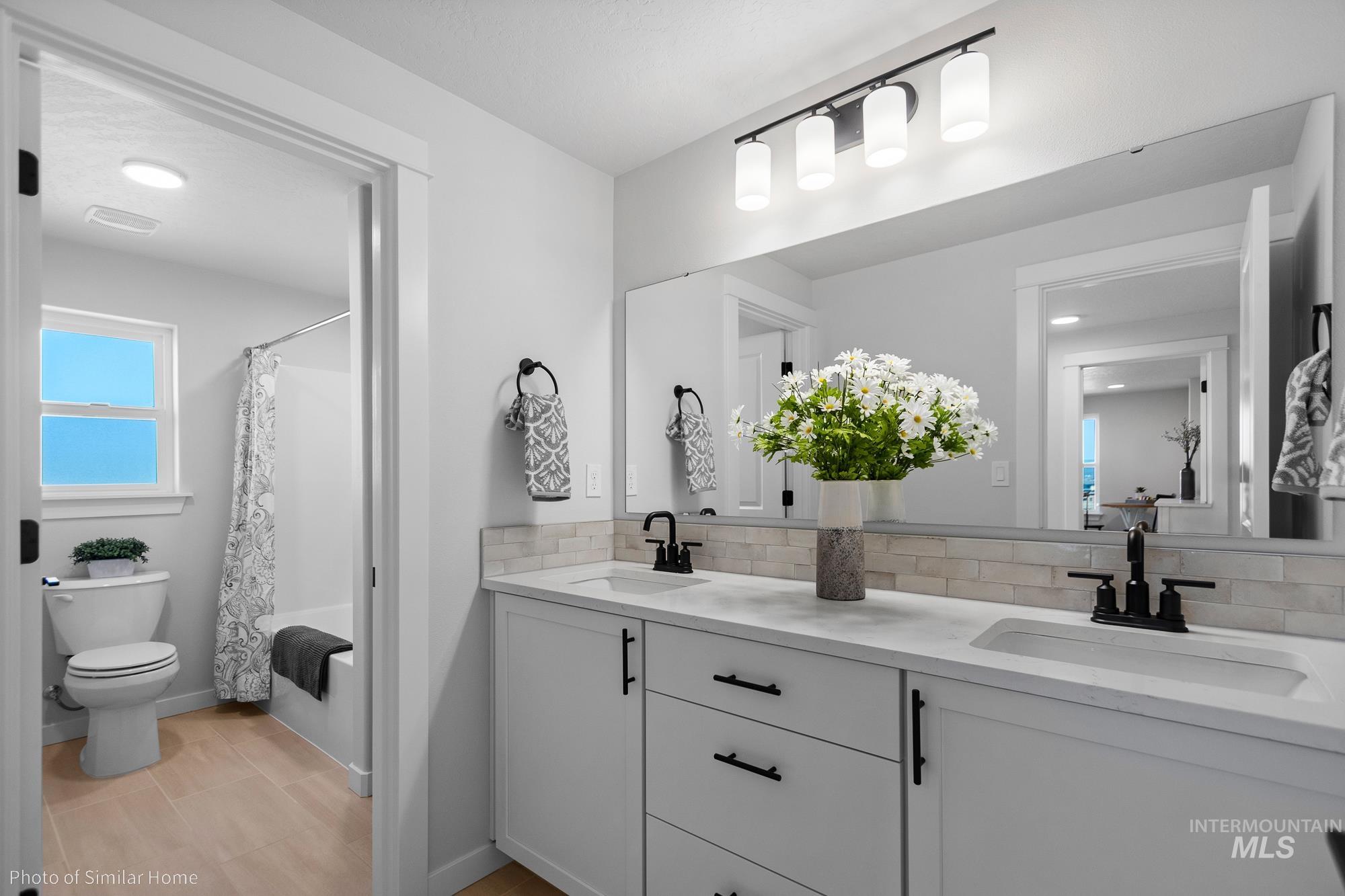 3 Tbd S Sorrel Trail Nampa, ID 83686 - Photo 14 of 17 Full bathroom featuring double vanity, shower / tub combo, and decorative backsplash