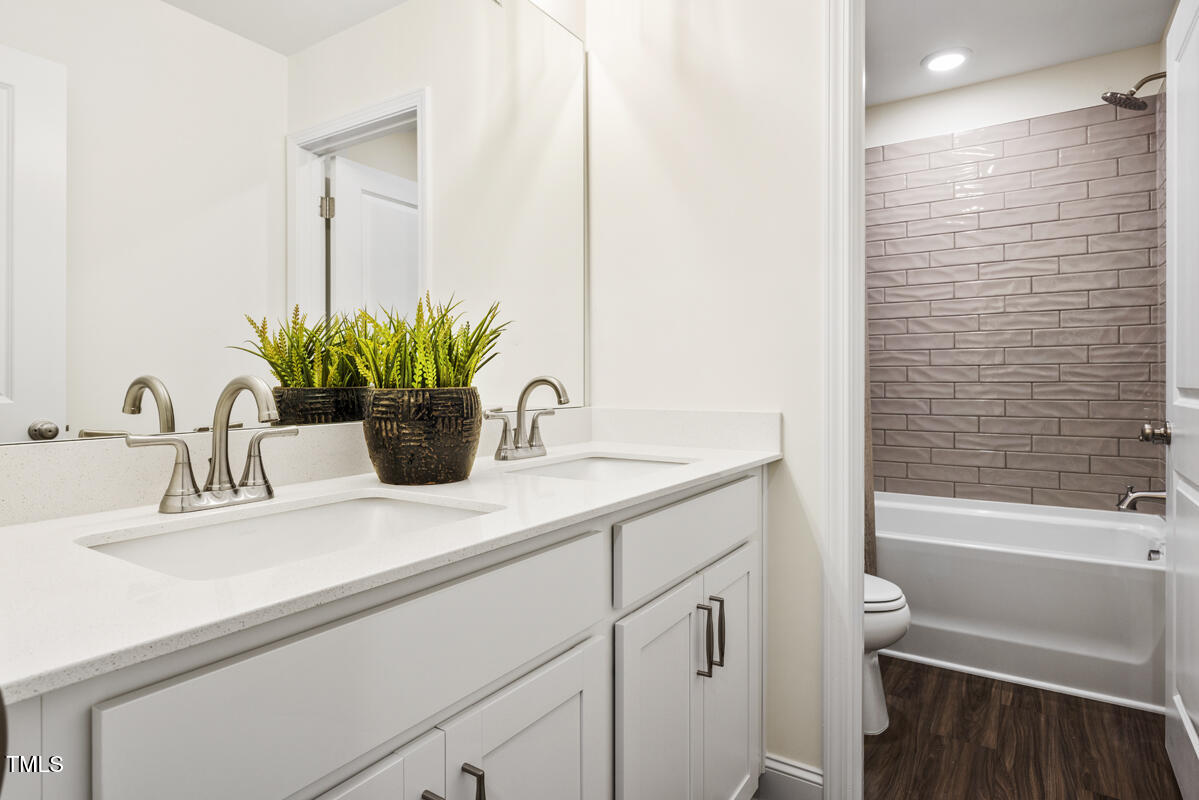 49 Alden Way Angier, NC 27501 - Photo 23 of 66 a bathroom with a sink a vanity and a bathtub