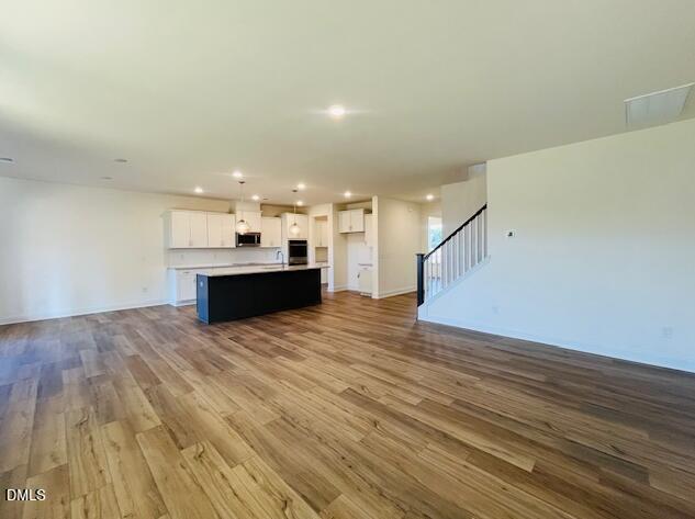 49 Alden Way Angier, NC 27501 - Photo 31 of 66 a view of kitchen and hall with wooden floor