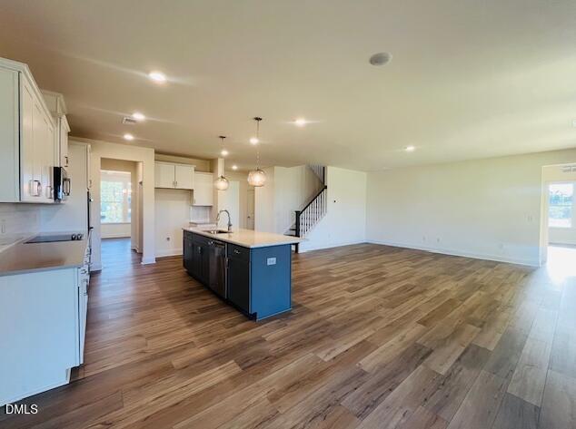 49 Alden Way Angier, NC 27501 - Photo 32 of 66 a kitchen with stainless steel appliances kitchen island a large counter top and a wooden floors