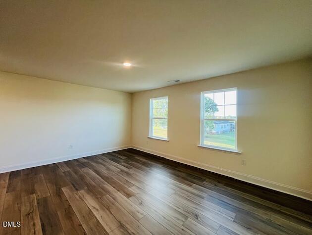 49 Alden Way Angier, NC 27501 - Photo 47 of 66 an empty room with wooden floor and windows