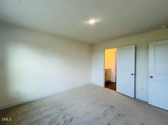 a room with wooden floor and windows