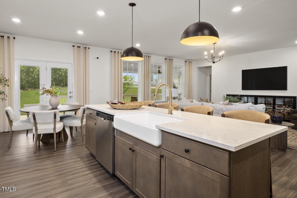 49 Alden Way Angier, NC 27501 - Photo 8 of 66 a large kitchen with kitchen island a sink table and chairs