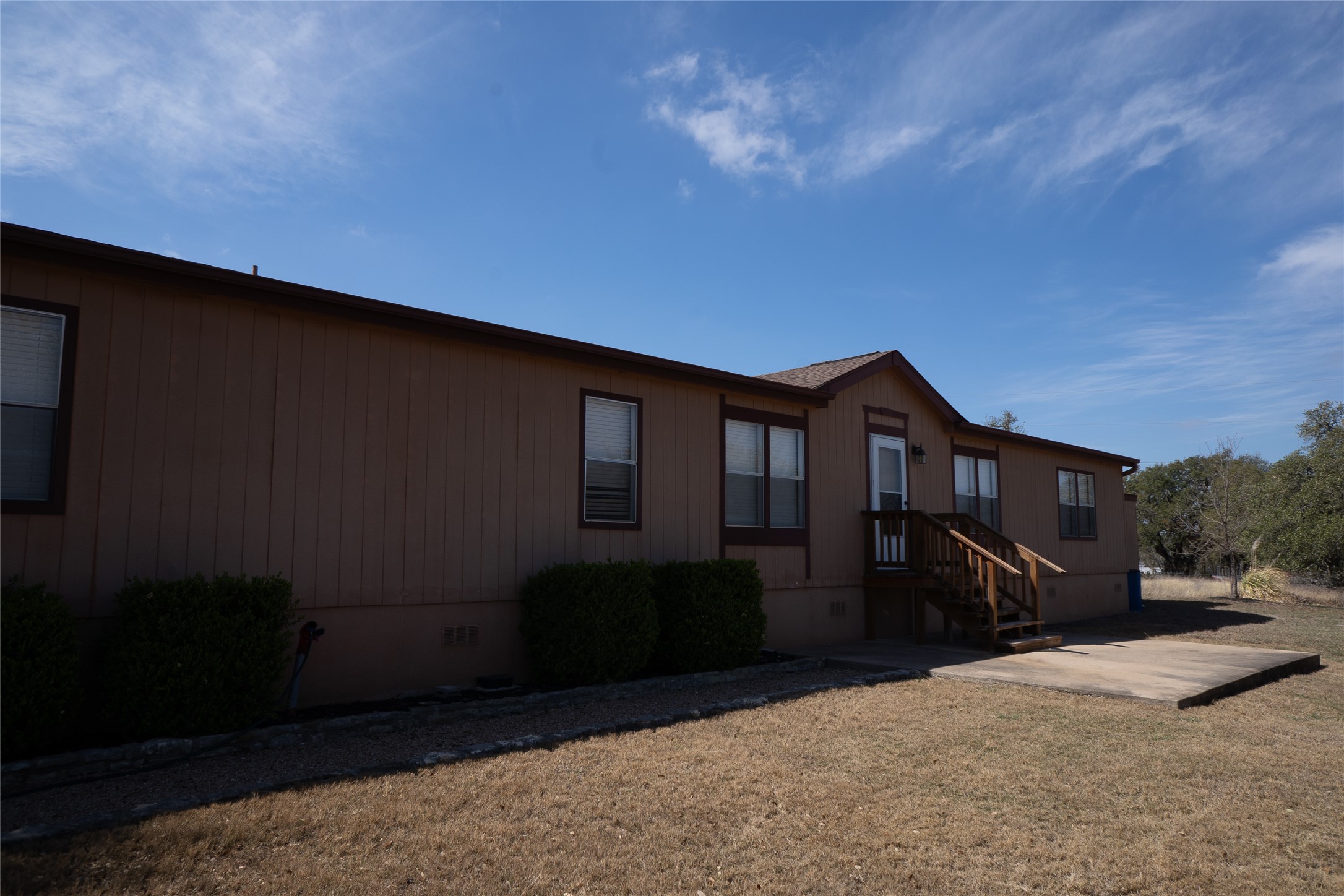 1149 Hart Lane Dripping Springs, TX 78620 - Photo 4 of 17 a front view of a house with a yard