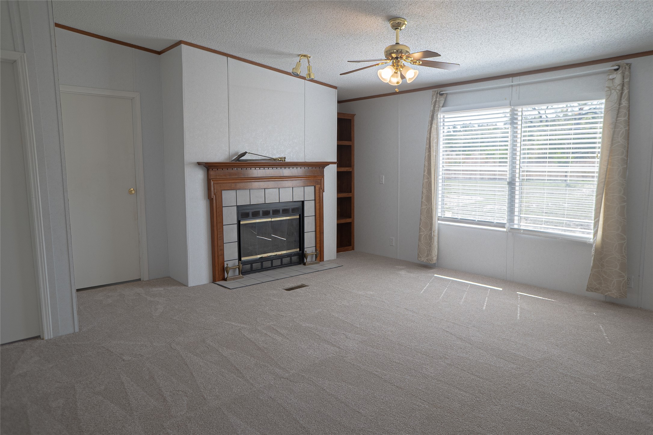 1149 Hart Lane Dripping Springs, TX 78620 - Photo 5 of 17 a view of empty room with fireplace and fan