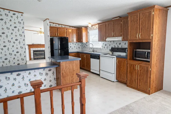 a kitchen with stainless steel appliances granite countertop a stove top oven a sink and dishwasher