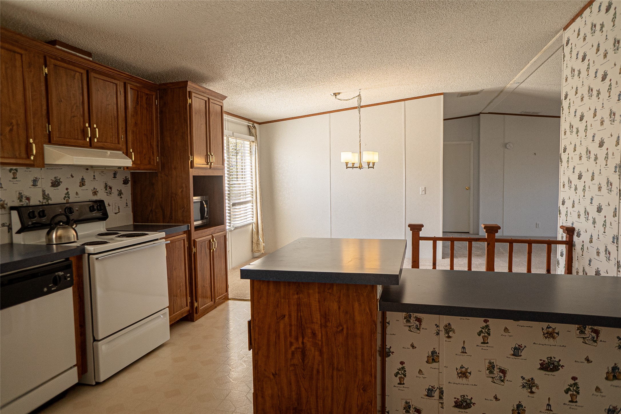 1149 Hart Lane Dripping Springs, TX 78620 - Photo 7 of 17 a kitchen with granite countertop a refrigerator and a stove top oven