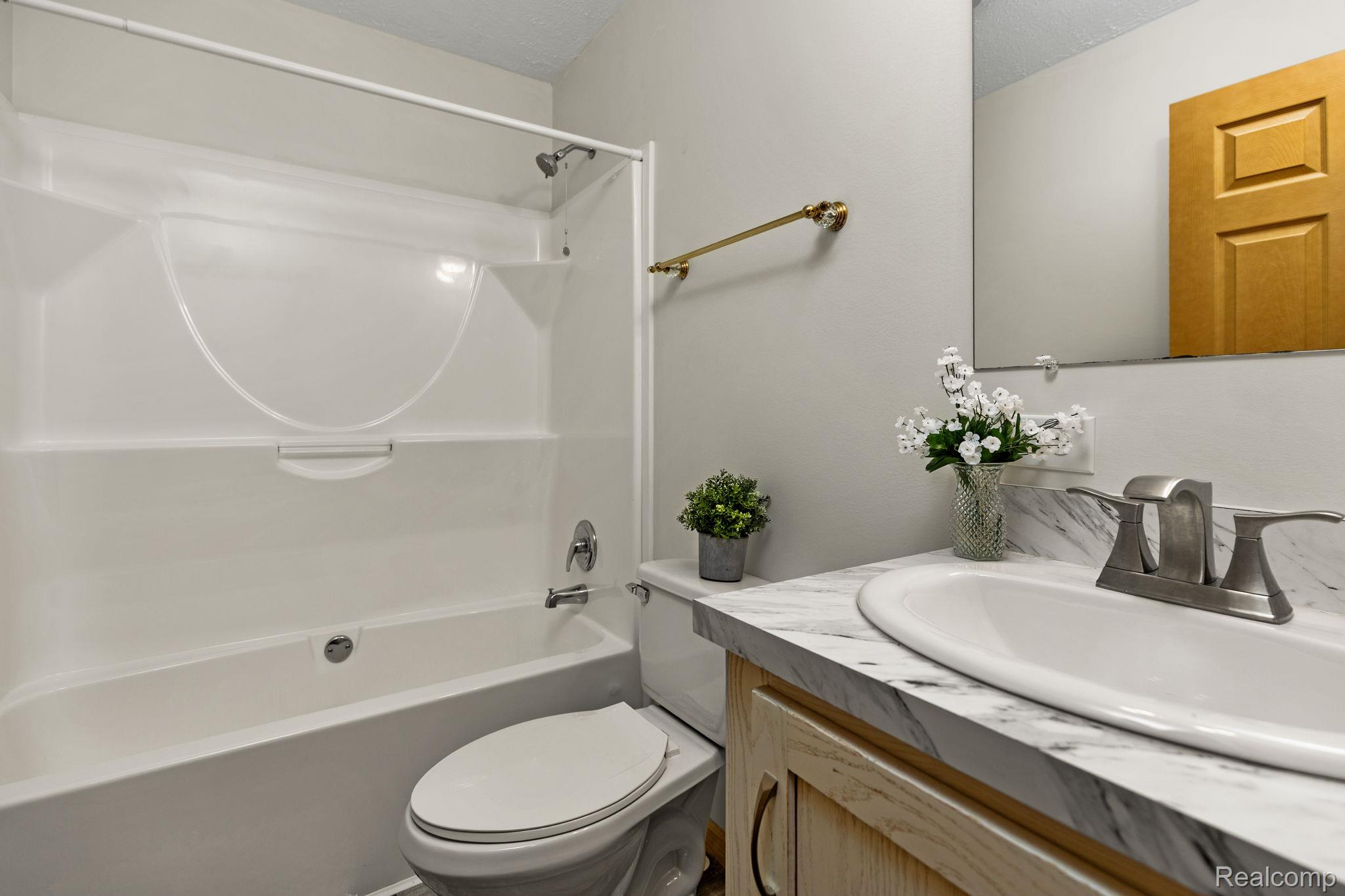 102 Wiard Road Ypsilanti, MI 48198 - Photo 23 of 37 Bathroom featuring vanity and bathtub / shower combination
