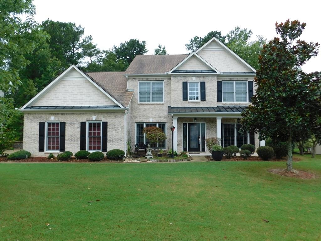 3009 Gold Creek Drive Villa Rica, GA 30180 - Photo 1 of 1 a front view of a house with a yard and trees