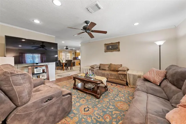a living room with furniture and kitchen view