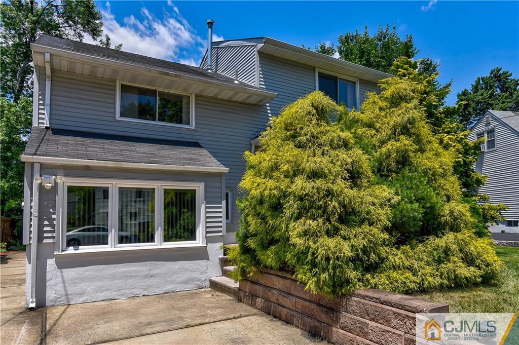 221 North Hill Road Colonia, NJ 07067 - Photo 2 of 25 a front view of a house with a garden