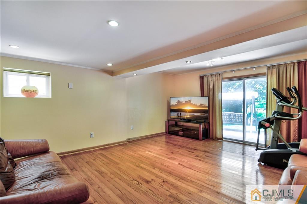 221 North Hill Road Colonia, NJ 07067 - Photo 11 of 25 a living room with furniture and a flat screen tv