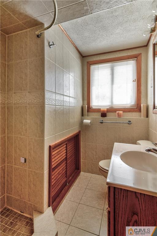 221 North Hill Road Colonia, NJ 07067 - Photo 12 of 25 a bathroom with a sink a toilet and a shower