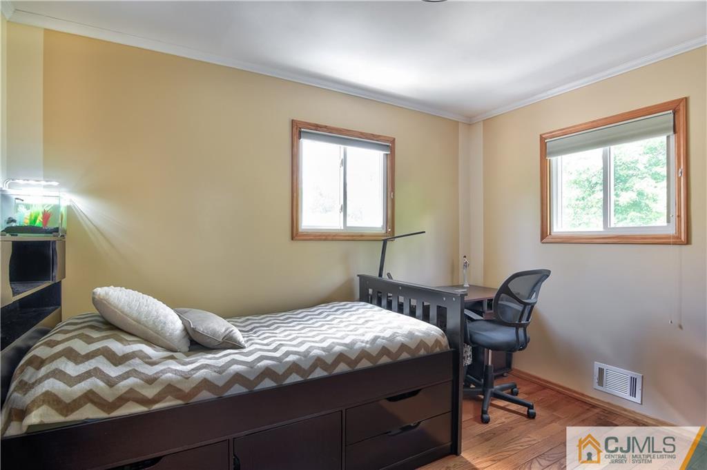 221 North Hill Road Colonia, NJ 07067 - Photo 21 of 25 a bedroom with a bed chair and a window