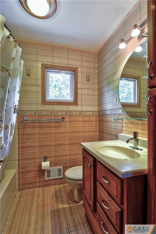 221 North Hill Road Colonia, NJ 07067 - Photo 22 of 25 a bathroom with a sink a toilet and mirror