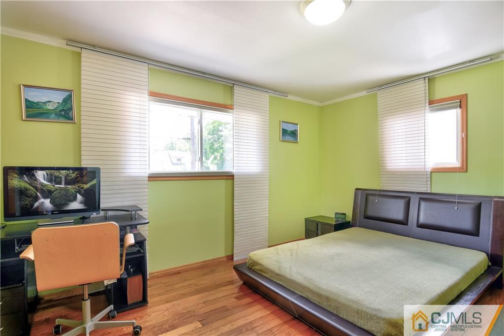 221 North Hill Road Colonia, NJ 07067 - Photo 23 of 25 a bedroom with a bed and wooden floor