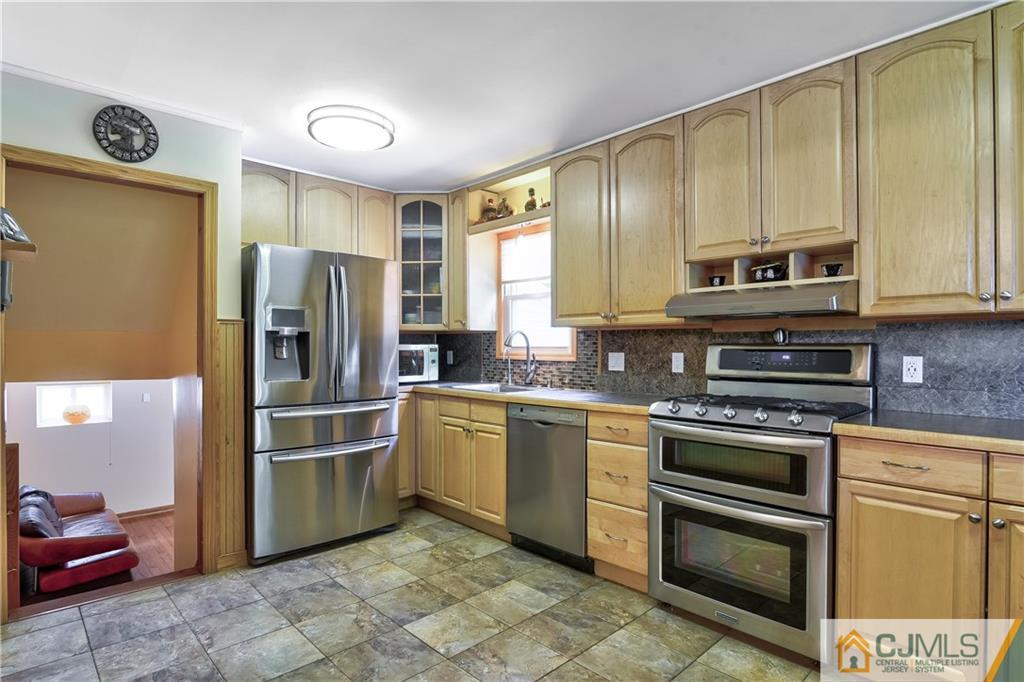 221 North Hill Road Colonia, NJ 07067 - Photo 8 of 25 a kitchen with stainless steel appliances granite countertop a refrigerator a stove a sink and dishwasher