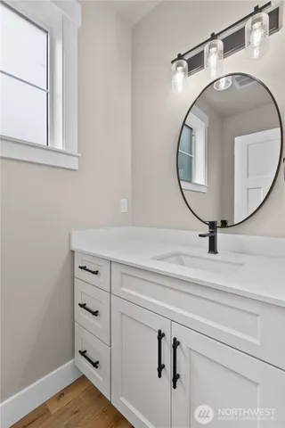 a bathroom with a sink and a mirror