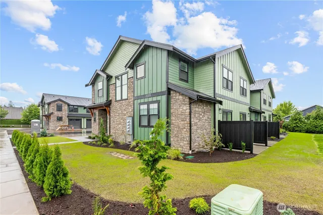a front view of a house with swimming pool having outdoor seating
