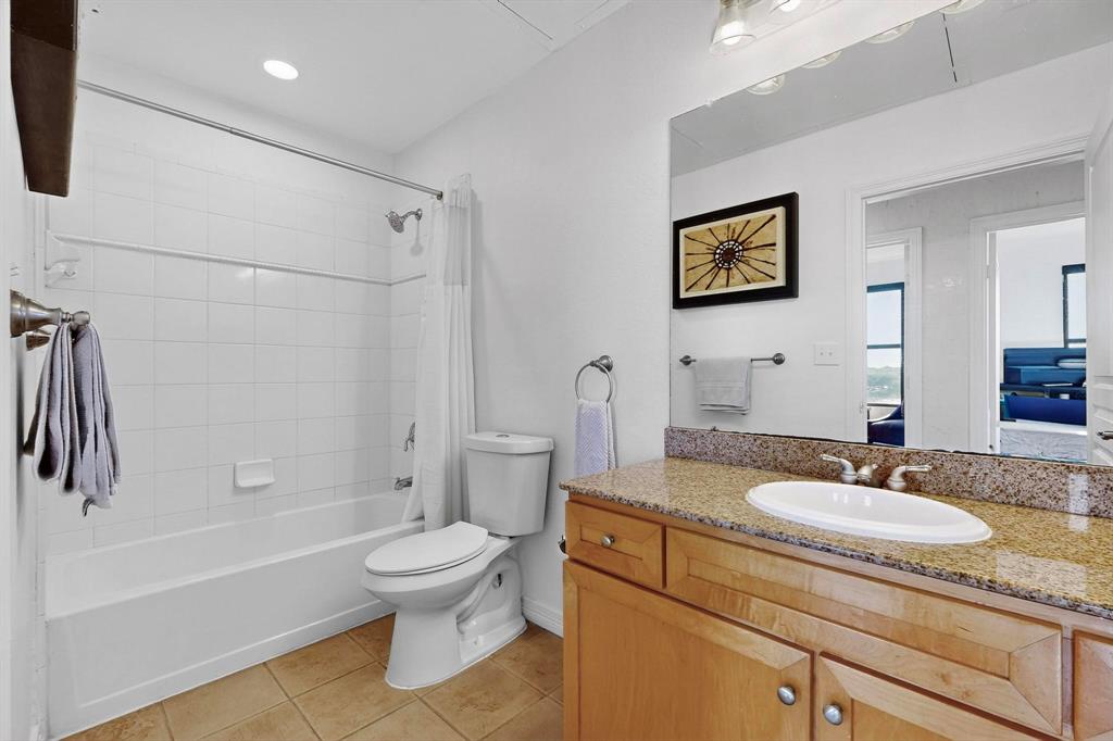 330 Las Colinas Boulevard East, Unit 1116 Irving, TX 75039 - Photo 11 of 36 a bathroom with a granite countertop sink a toilet and a bathtub