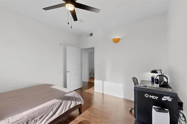 a bedroom with a bed couch and window