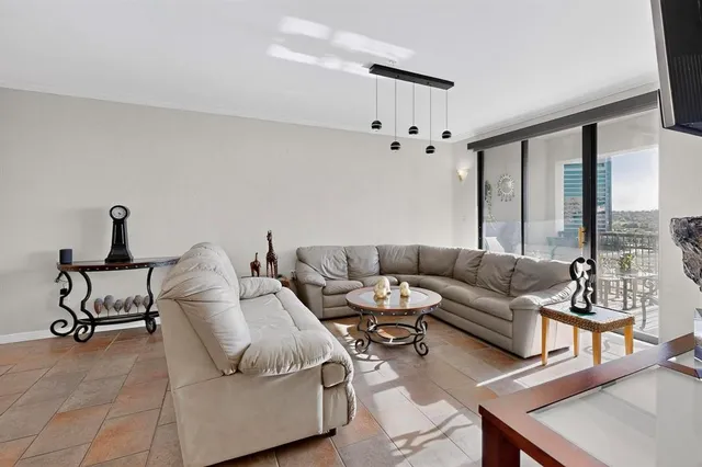 a living room with furniture and a large window