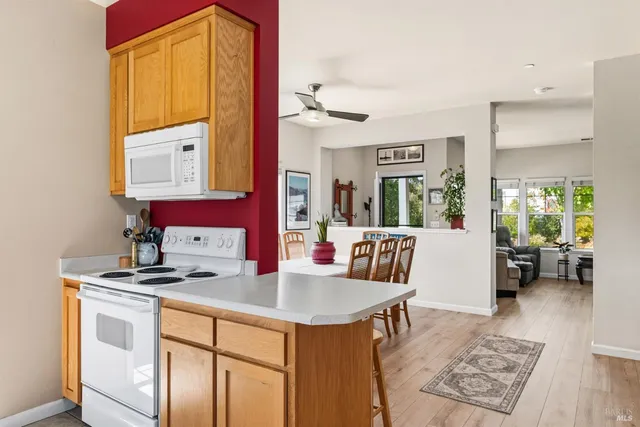 a kitchen with sink cabinets and dining table