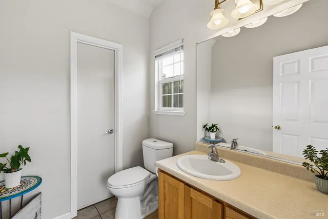 a bathroom with a sink toilet and a mirror