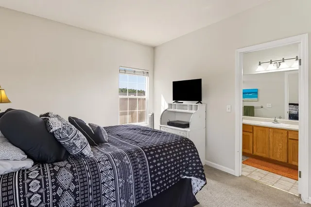 a bedroom with a bed and a television