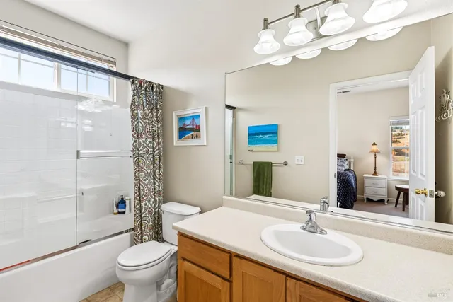 a bathroom with a sink toilet a mirror and shower