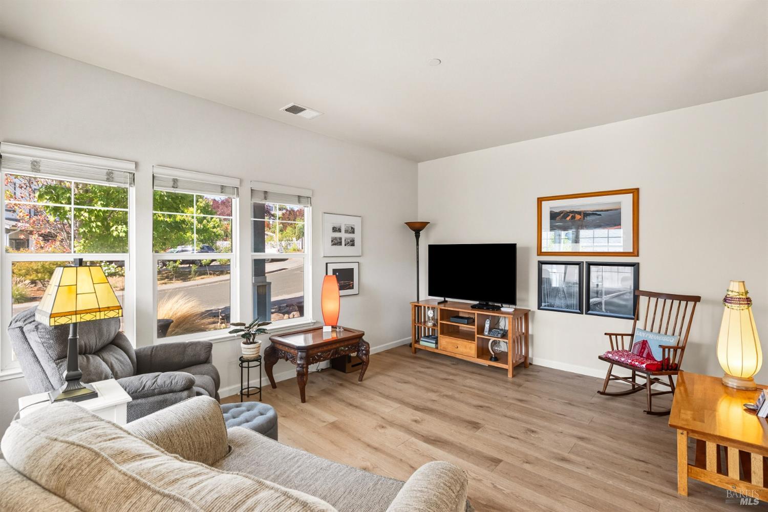 1724 Palomino Court Healdsburg, CA 95448 - Photo 4 of 30 a living room with furniture floor to ceiling window hardwood floor and a flat screen tv