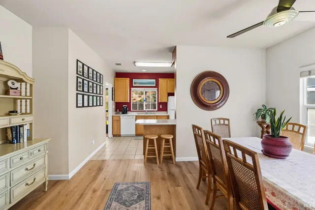 a dining room with furniture and a wooden floor