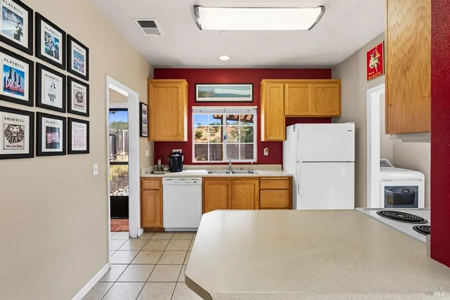 a kitchen with a refrigerator and a stove top oven