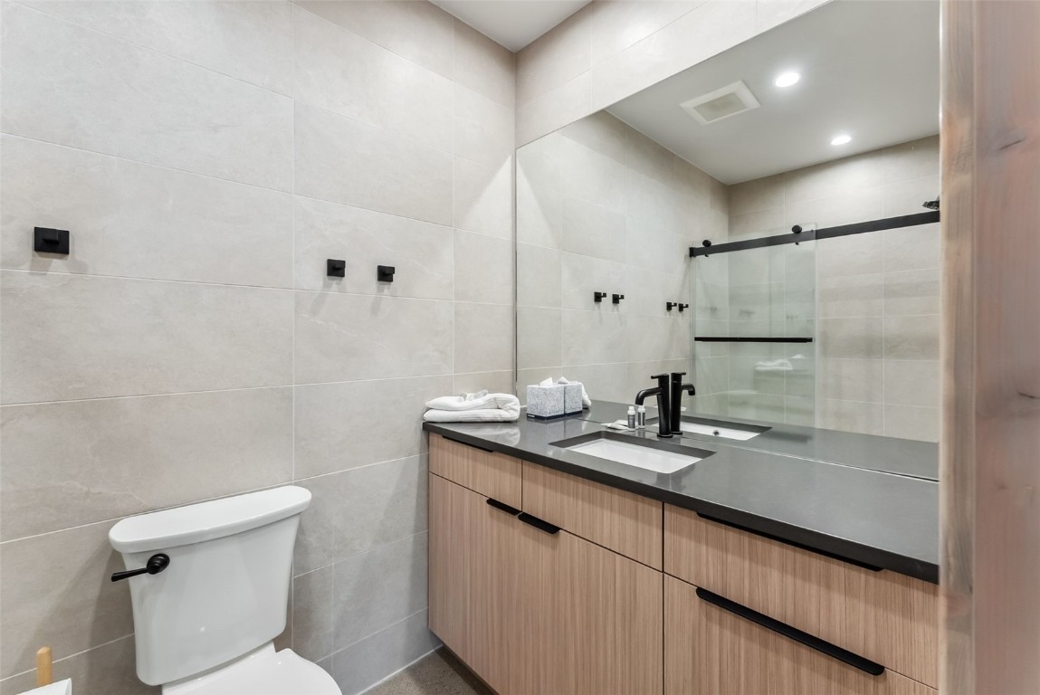 96 River Run Road, Unit A Keystone, CO 80435 - Photo 22 of 50 a bathroom with a granite countertop sink a mirror and a toilet