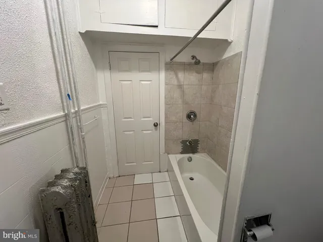 a bathroom with a bathtub a toilet and a shower