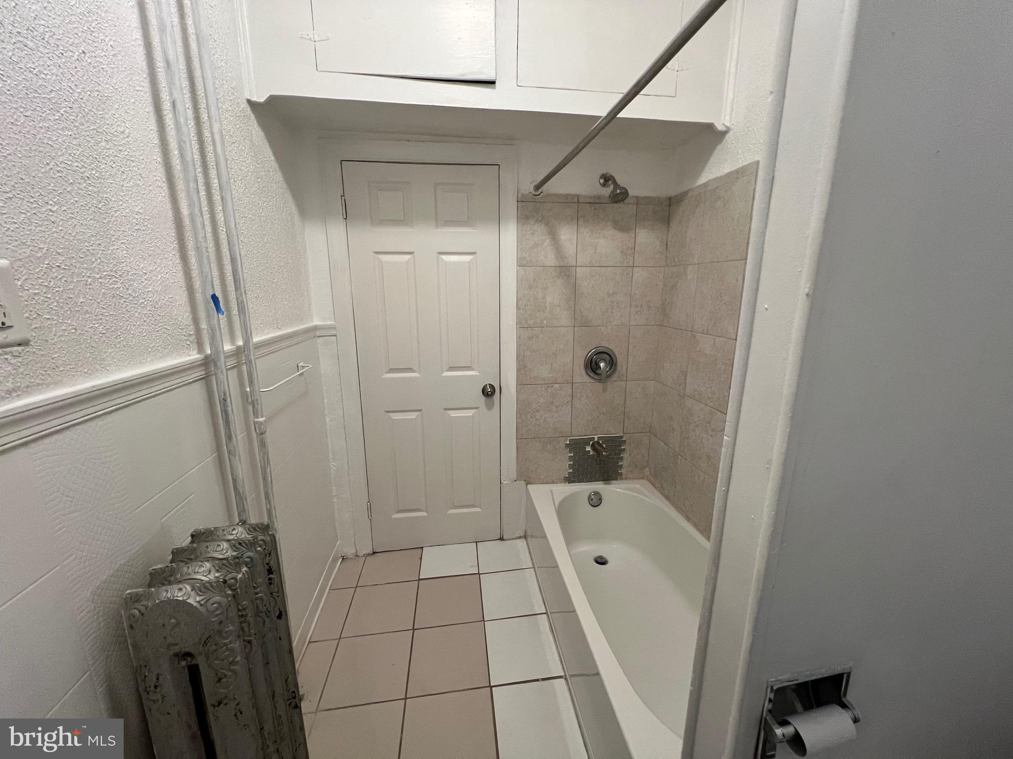 5533 Walnut Street, Unit 1 Philadelphia, PA 19139 - Photo 11 of 20 a bathroom with a bathtub a toilet and a shower