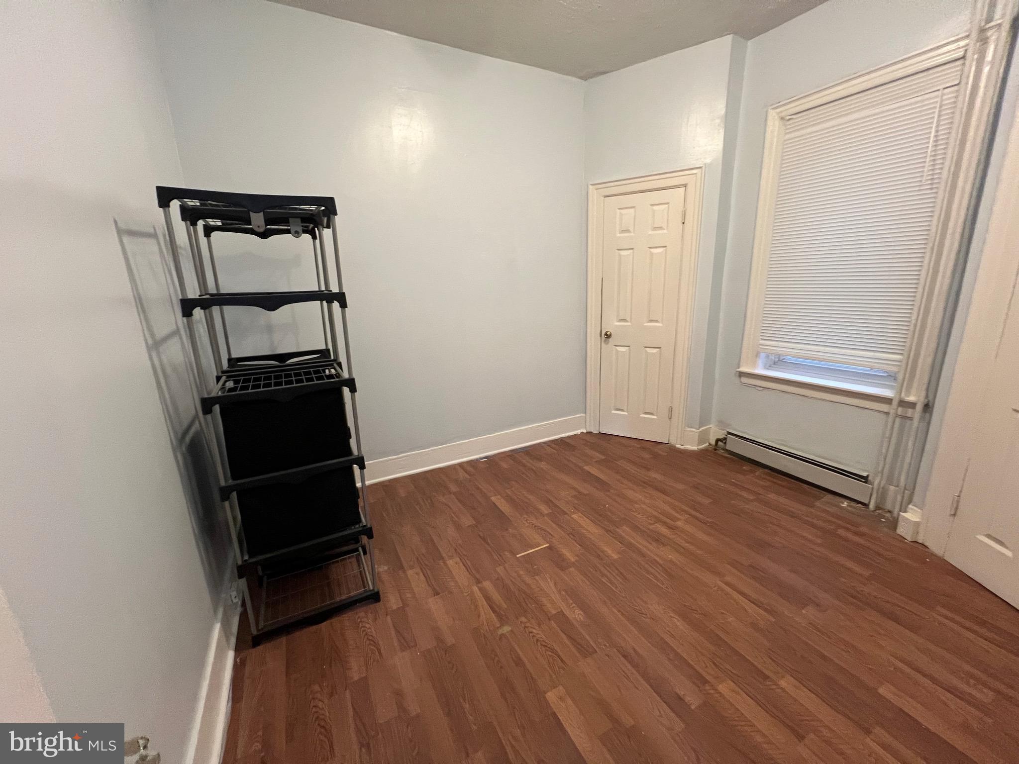 5533 Walnut Street, Unit 1 Philadelphia, PA 19139 - Photo 12 of 20 an empty room with wooden floor and closet
