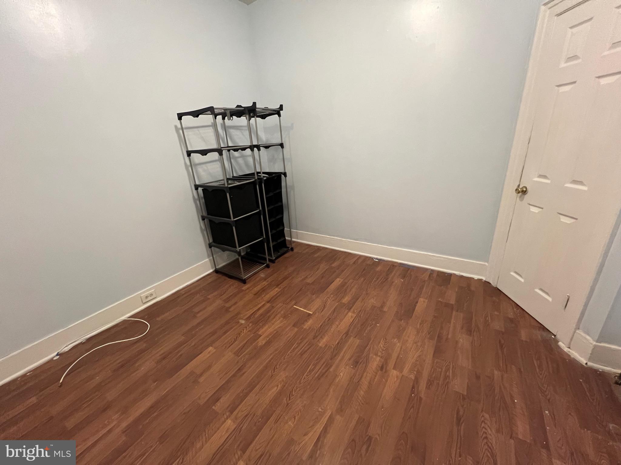 5533 Walnut Street, Unit 1 Philadelphia, PA 19139 - Photo 14 of 20 an empty room with wooden floor and white walls