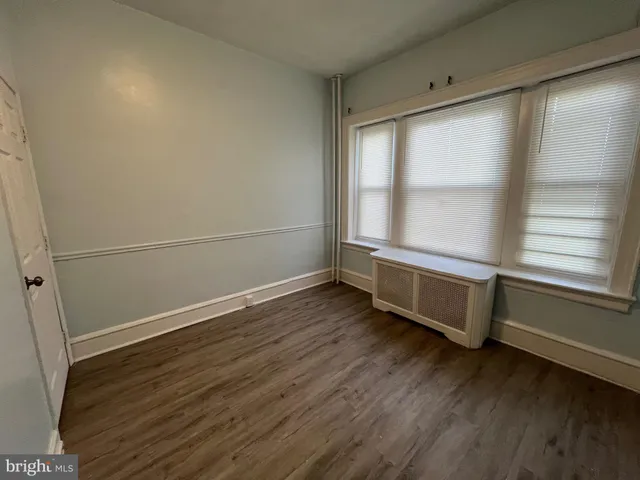 a room with wooden floor and window