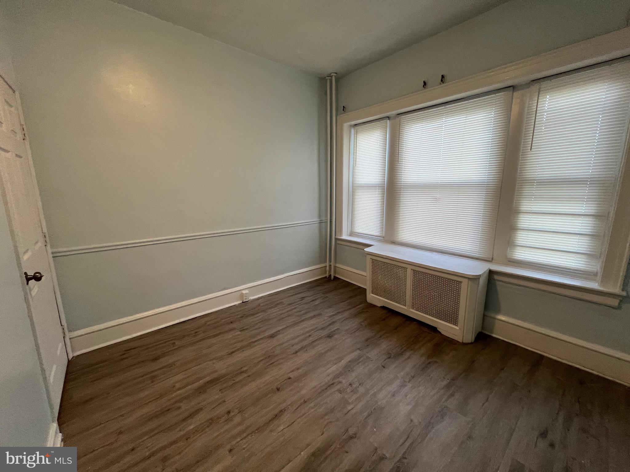 5533 Walnut Street, Unit 1 Philadelphia, PA 19139 - Photo 16 of 20 a room with wooden floor and window