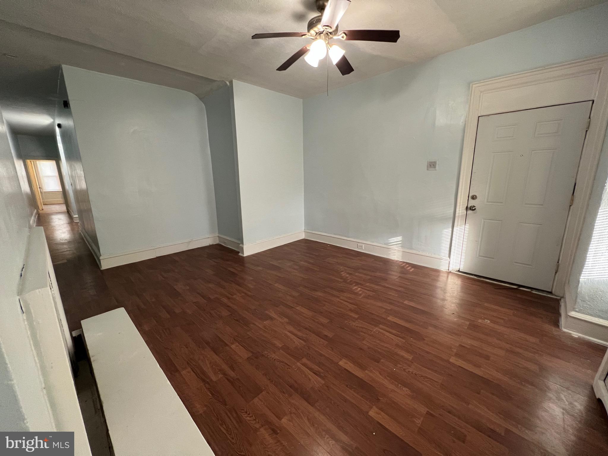 5533 Walnut Street, Unit 1 Philadelphia, PA 19139 - Photo 4 of 20 an empty room with wooden floor and staircase