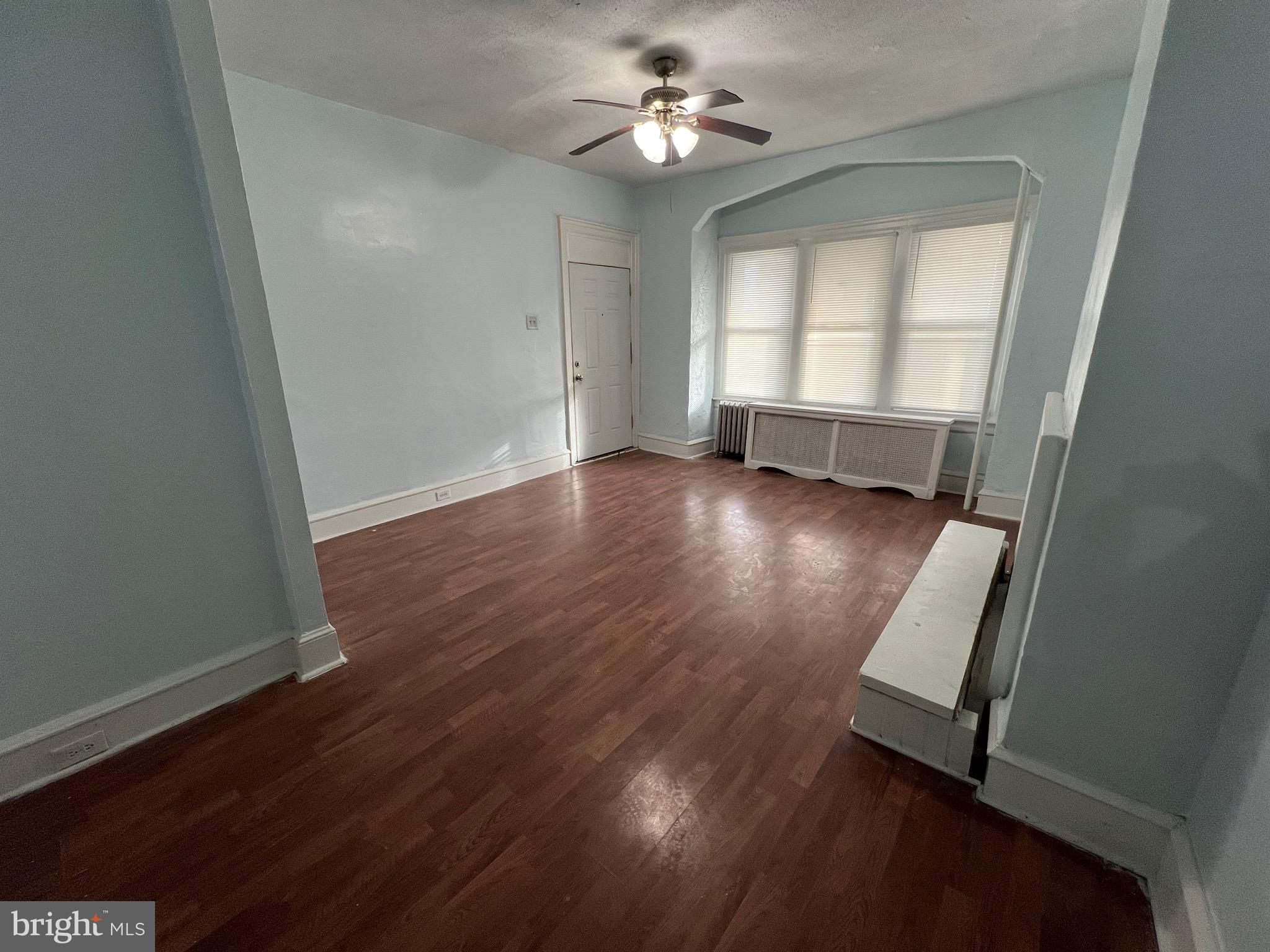 5533 Walnut Street, Unit 1 Philadelphia, PA 19139 - Photo 5 of 20 an empty room with wooden floor and windows