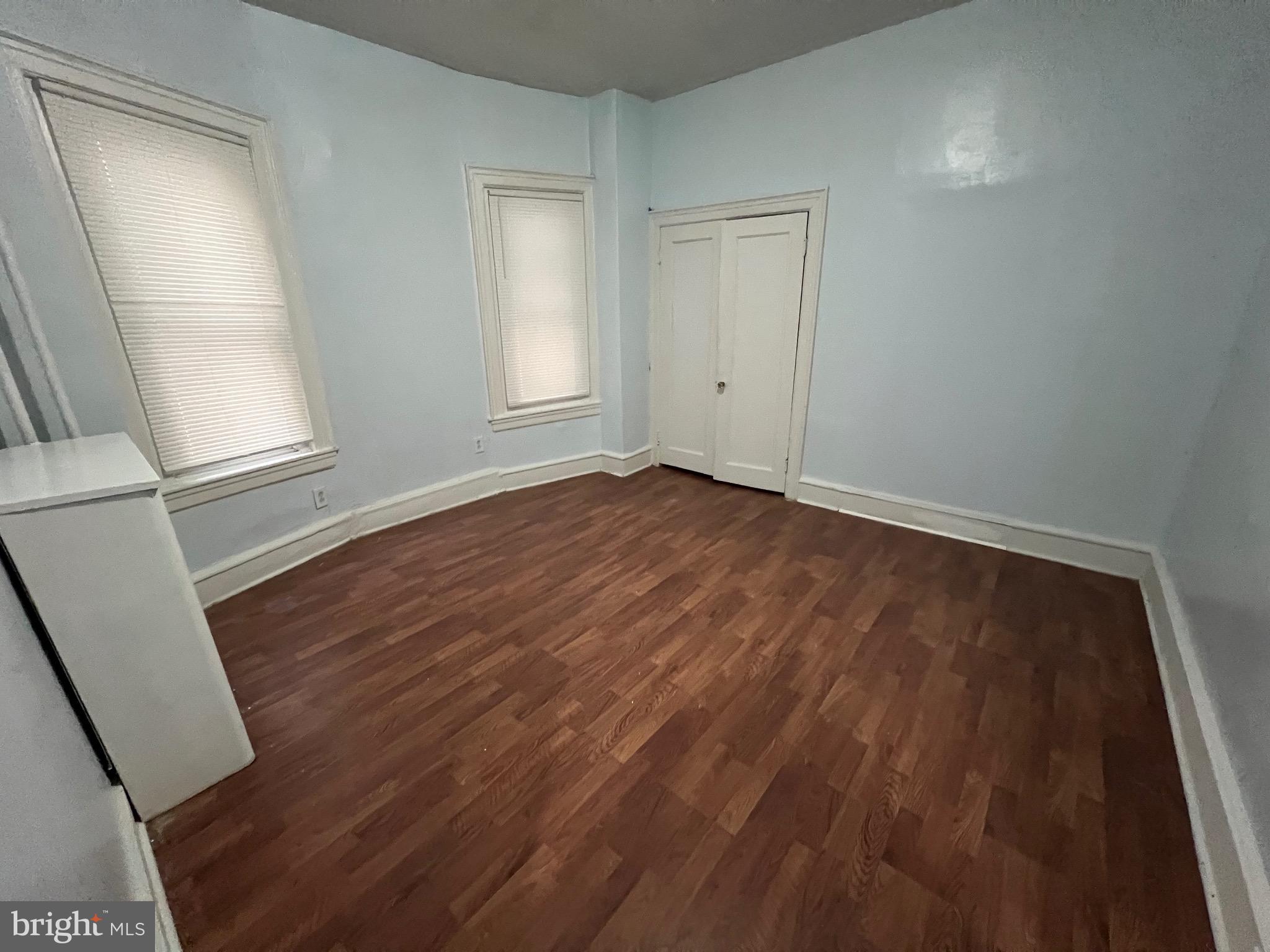 5533 Walnut Street, Unit 1 Philadelphia, PA 19139 - Photo 7 of 20 an empty room with wooden floor and windows